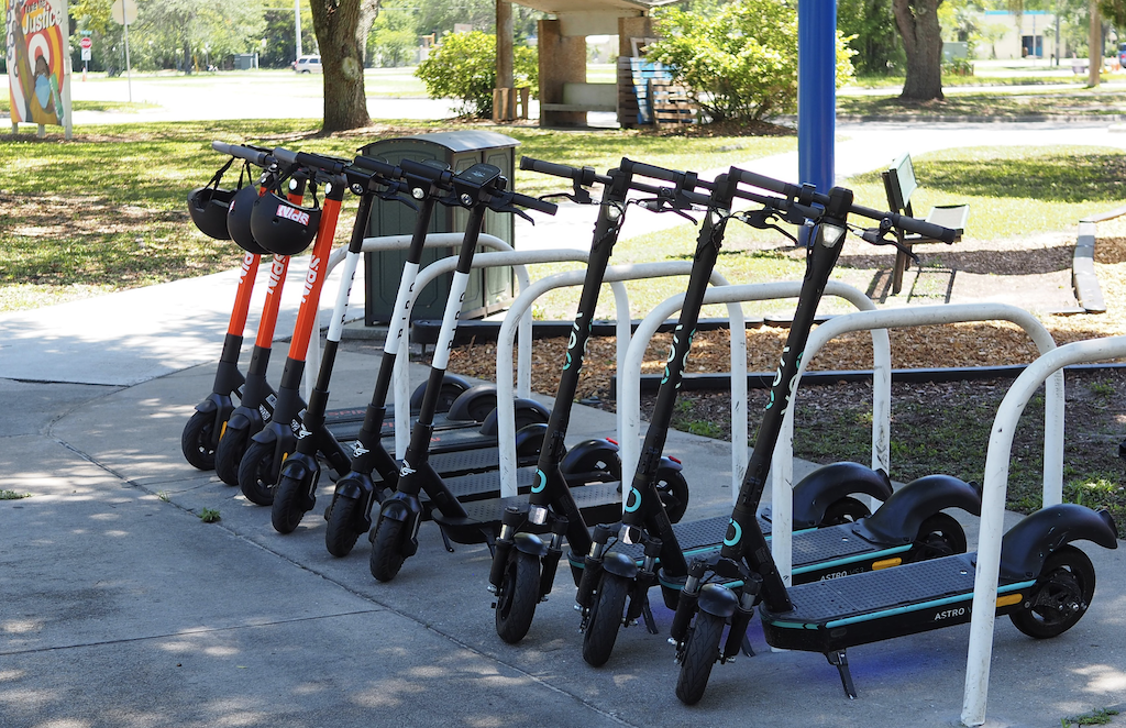 Scooters lined up on sidewalk