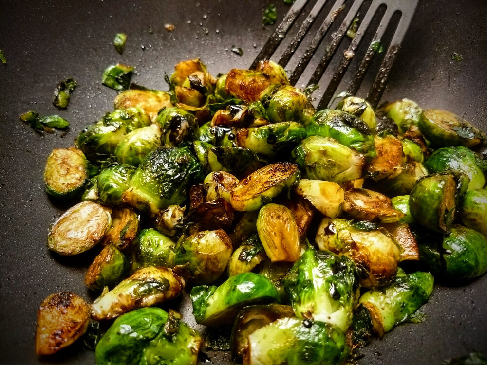 Brussels sprouts in pan with spatchula