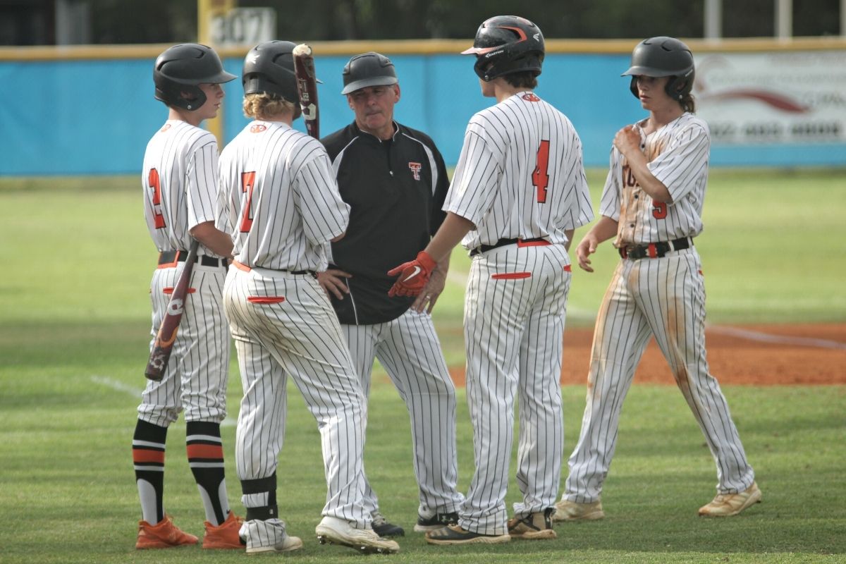 Trenton coach Scott Hall talks things over with batters