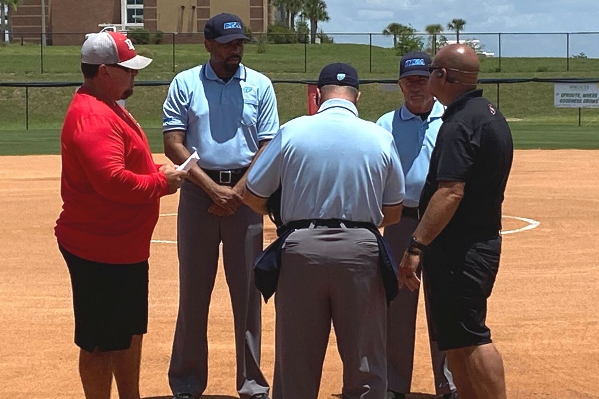 Dixie County coach Greg Wimberley and Fort White coach Chad Padgett meet with officials