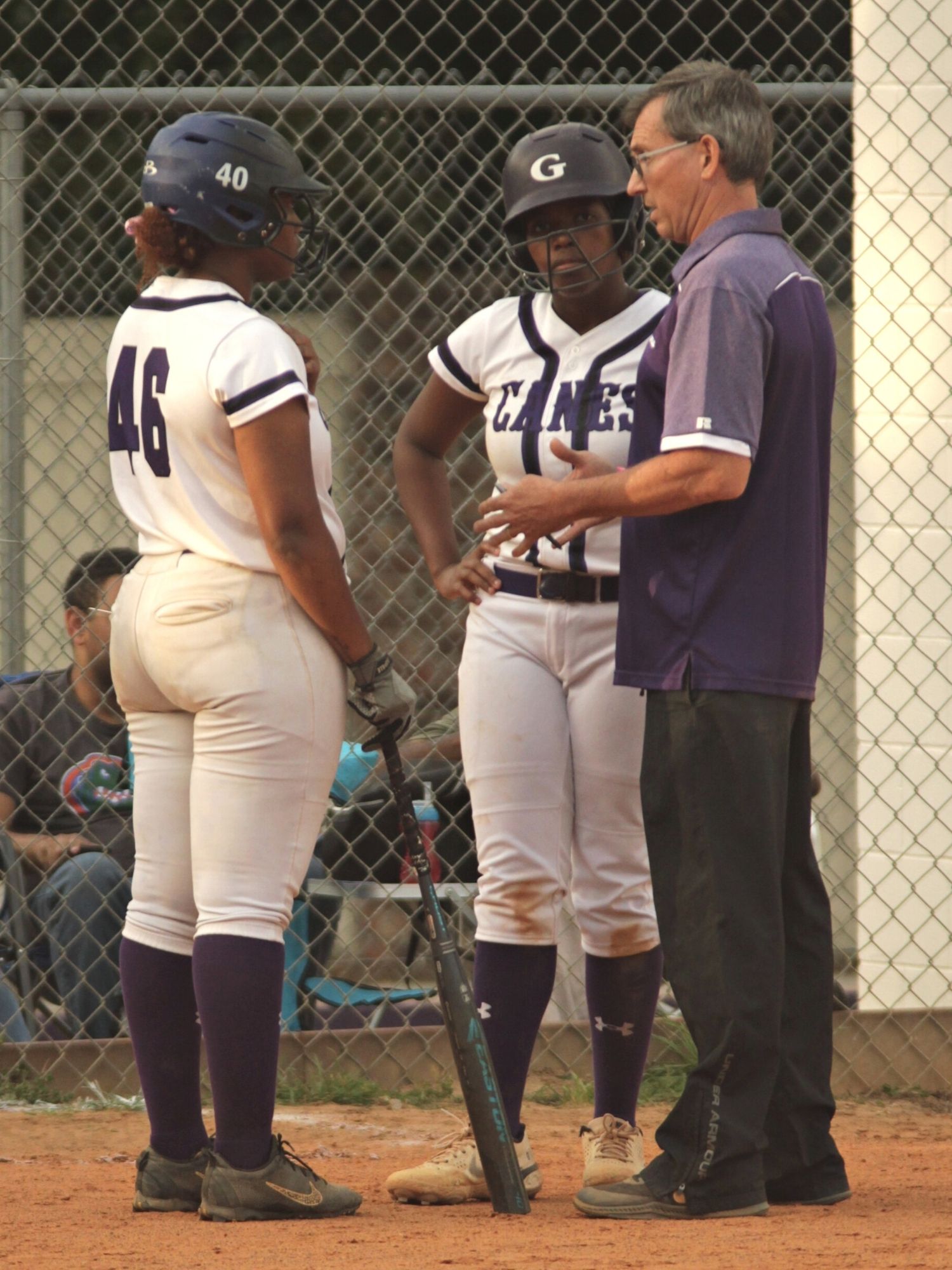 Gainesville coach Chris Chronister talks with Kam Sumler (46) and Michaela Cromarty