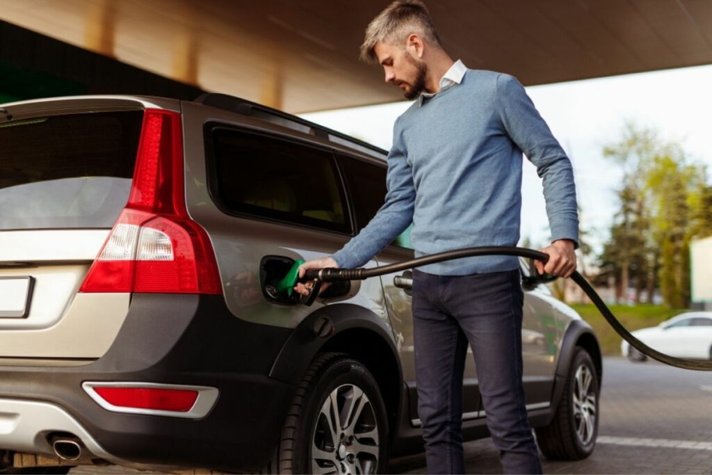 Man pumping gas into car