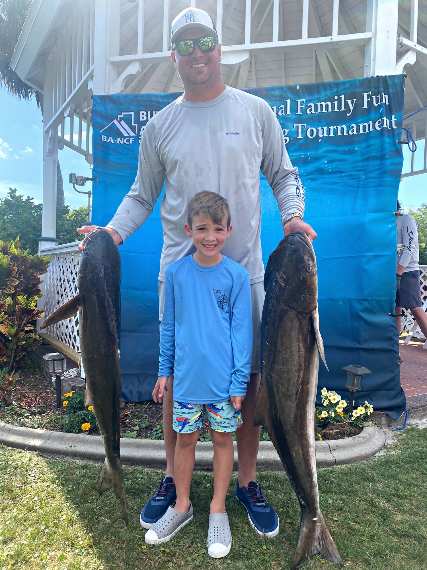 Walker Robinson and his dad with their winning cobia catches