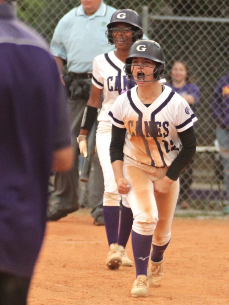 Gainesville's Karter Thorp (12) and Jayla Clark score the Hurricanes' first two runs to tie the game against Milton on a Parris Wiggs triple.