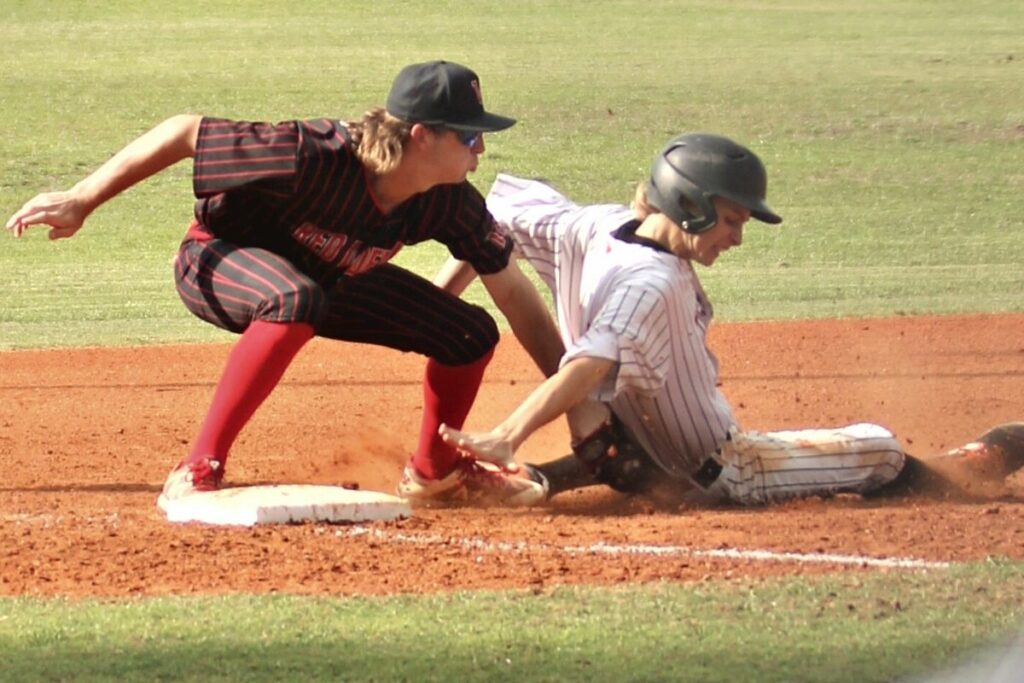 Williston's Hunter Bullock tags Trenton's Stephen Furst out at third base in bottom of fifth inning on Monday.