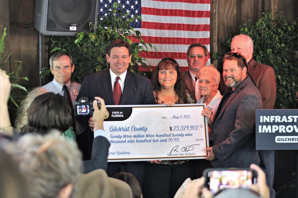 Gov. Ron DeSantis presenting a $23 million check to Gilchrist County
