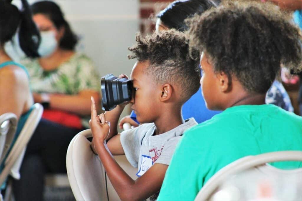Evan plays with virtual reality goggles during the event.