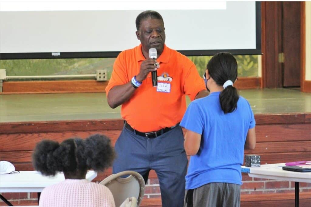 John Rollins with Motiv8u rewards a attendee with a $5 bill