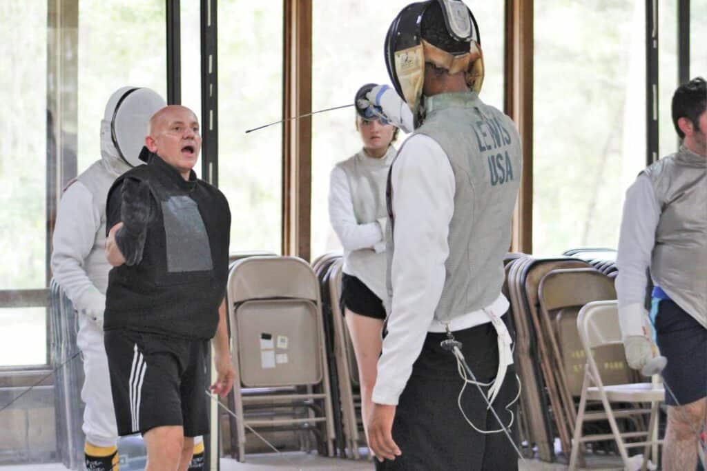 Julio Diaz instructs at fencing class