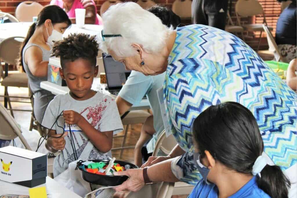 Merrie Lynn Parker works with two attendees at the New Tech Now event