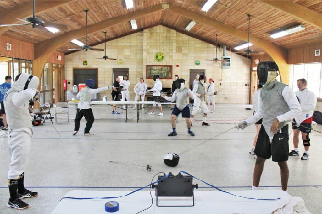 Students pair up to drill fencing concepts