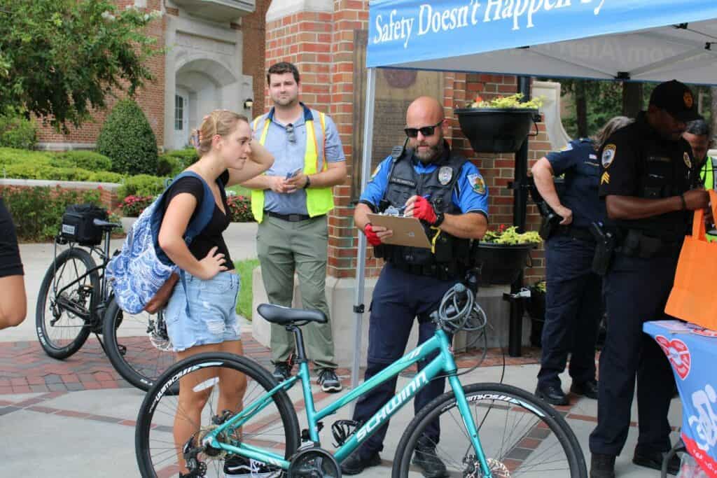 A UF Police Department officer registers a student's bike.