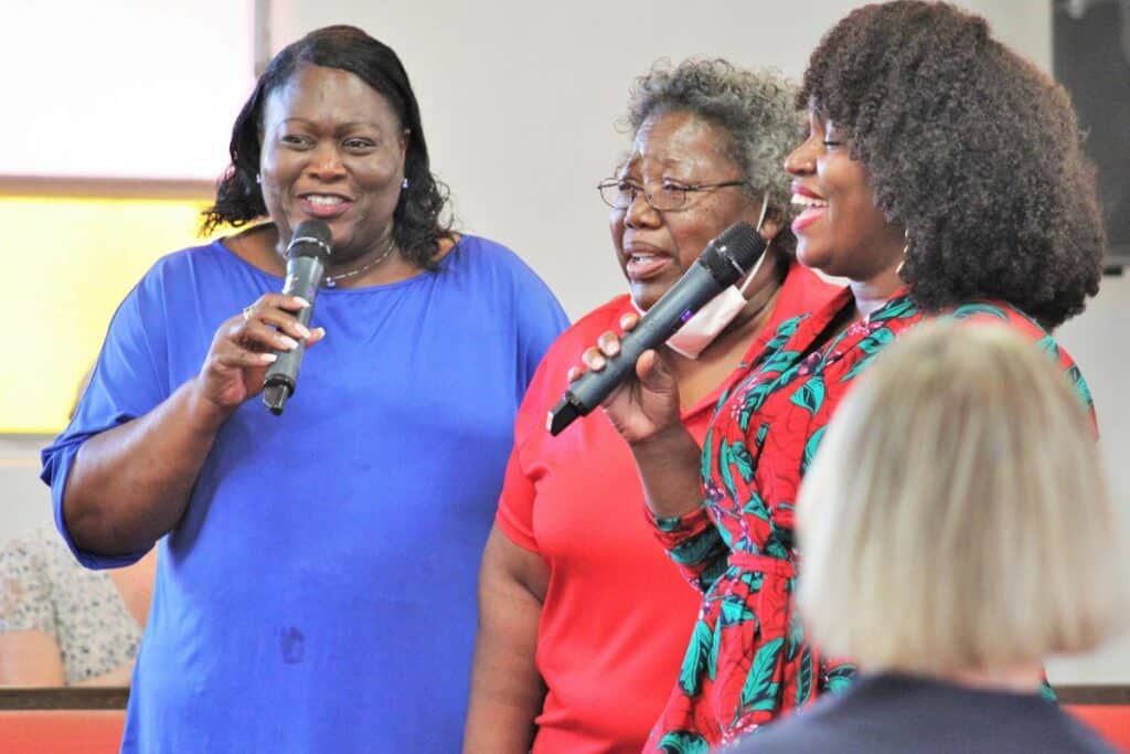 A trio sang This Little Light of Mine at rally