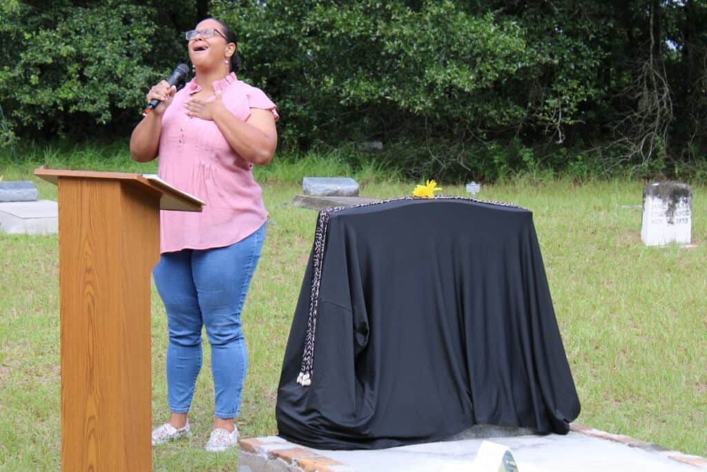 Ashley Hill sings, “His Eye is on the Sparrow,” during the remembrance ceremony.