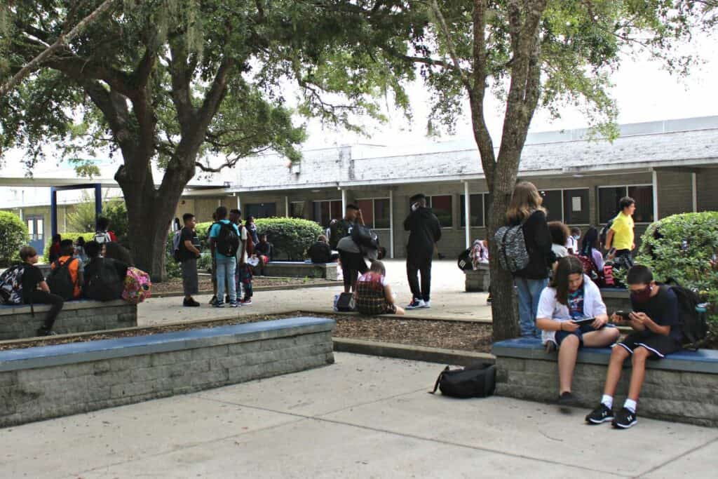 Fort Clark Middle School students waiting for the bus