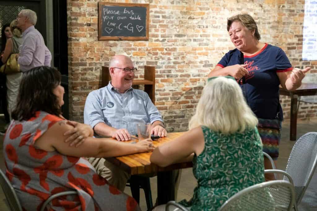 Gainesville mayoral candidate Harvey Ward (second from left) at an election watch party on Tuesday.