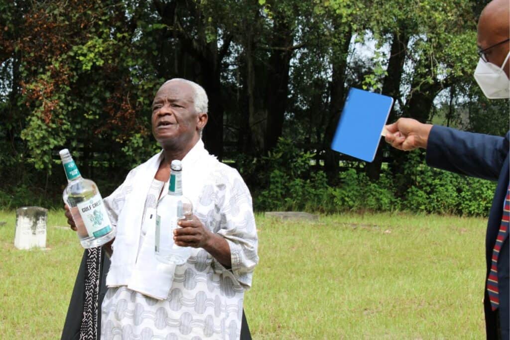 Nii Sowa La performs libation, an African tradition of pouring a liquid as an offering in memory of those who passed.