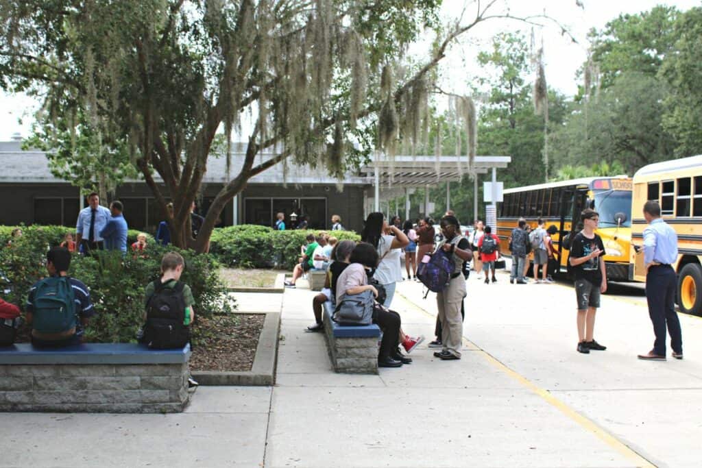 Students at Fort Clark Middle School bus pickup