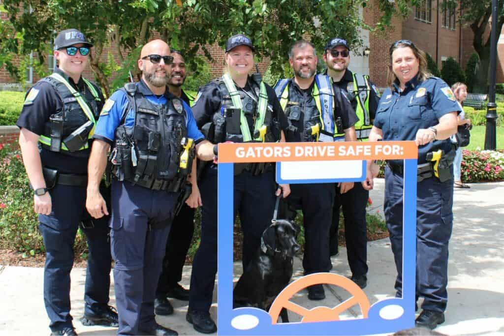 UF Police Department and FDOT members grab a group picture with a new police puppy in training.