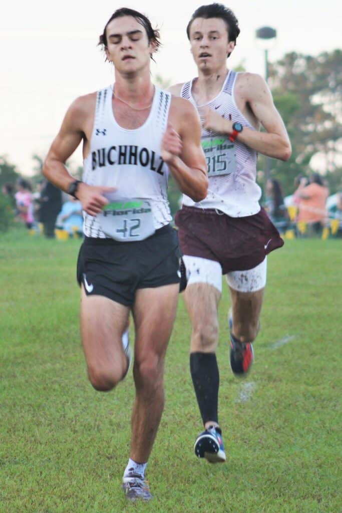 Buchholz runner Emerson Miller and Oak Hall's Caden Montini round out the last kilometer at the Bobcat Classic Invite, finishing first and second respectively.