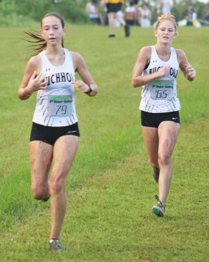 Buchholz runners Eleanor Whisler, left, and Kate Drummond, right, finished fifth and fourth overall at the Bobcat Classic Invite.