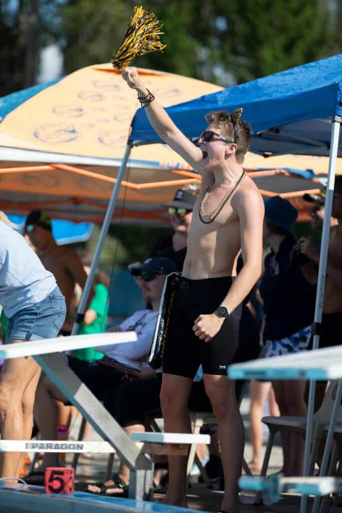 Buchholz's Malachi Walters cheers on teammate Asher Bitton during the boys 100-yard backstroke.