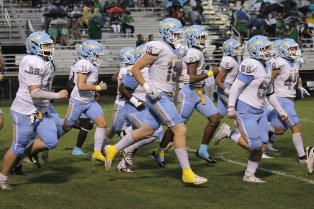 Chiefland Indians football team running onto field