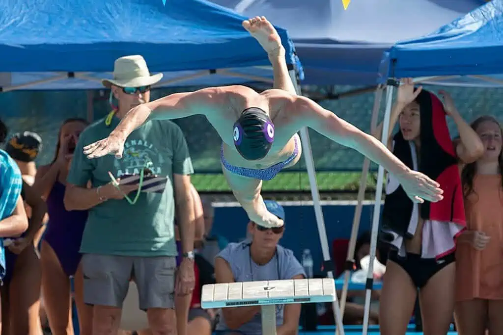 Gainesville's Michael Mullen dives into the boys 100-yard breaststroke.