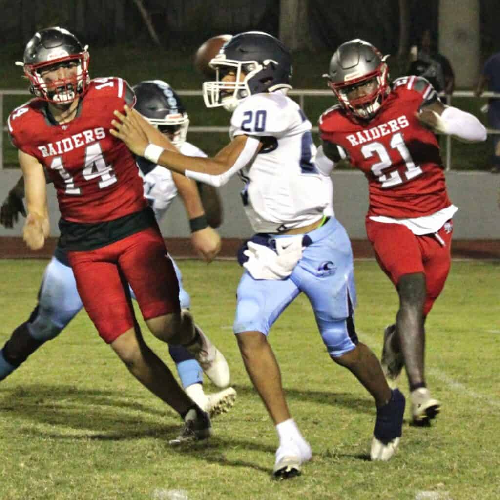 P.K. Yonge's Adrian Curtis escapes Santa Fe's Ethan Thomas (14) and Calel Perry (21).