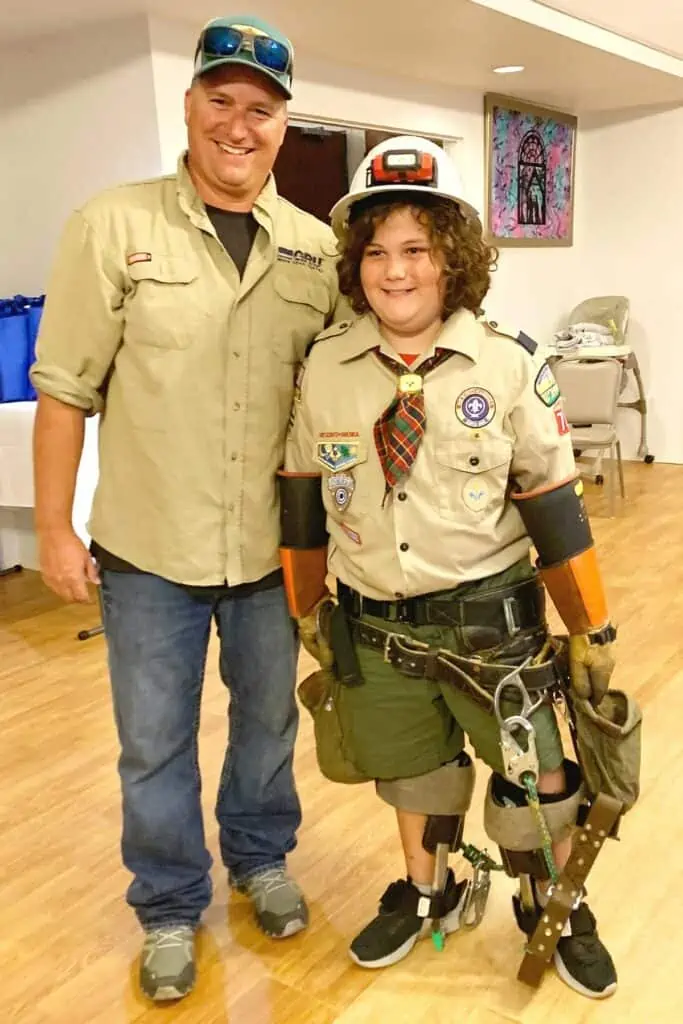 Cub Scout Brock LaPlant is suited up in GRU lineworker Alvin Moore’s gear