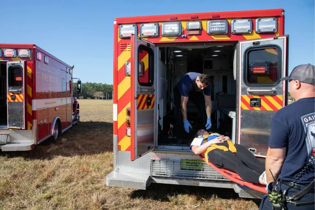 Emergency responders load Santa Fe Community College EMT student Caleigh Kiefer into an ambulance.