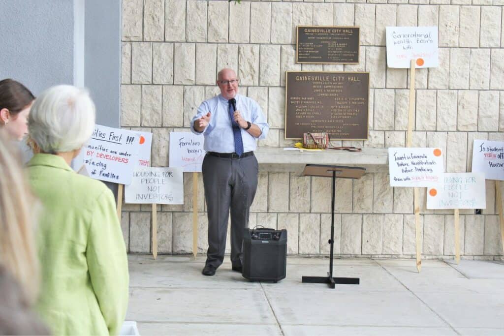 Gainesville commissioner and mayoral candidate Harvey Ward spoke against eliminating single-family zoning in a protest rally prior to Monday's meeting.