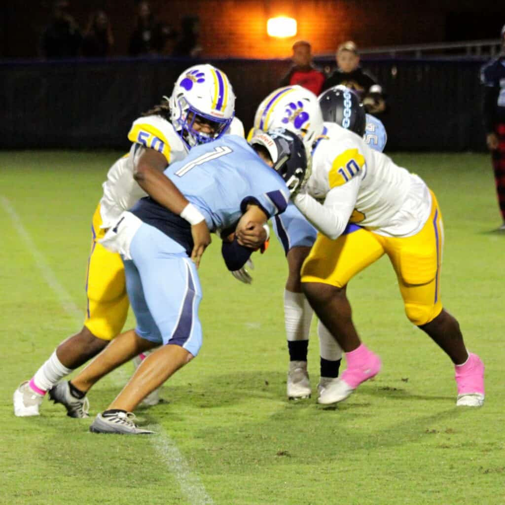 Newberry's Caleb Cobbs (50) and Logan McCloud (10) tackle P.K. Yonge's Devin Pedro on Friday.