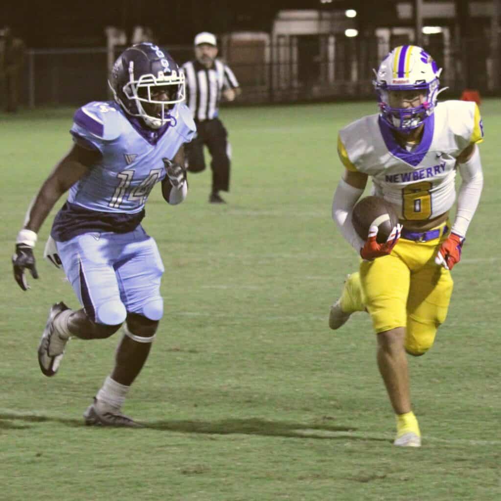 Newberry's David Schmidt outraces P.K. Yonge's Ernest Davis on Friday.