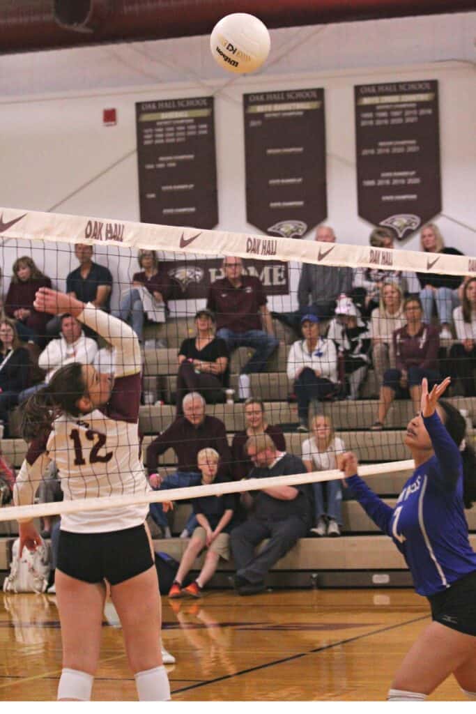 Oak Hall's Cassidy McDonald hits the ball over the next against St. Francis on Wednesday.