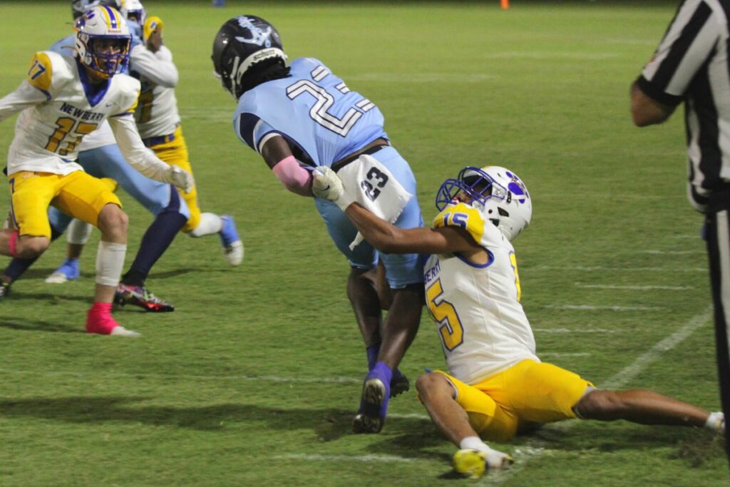 P.K. Yonge's Jammel Gillins tackled by Newberry's Christian Rich on Friday.