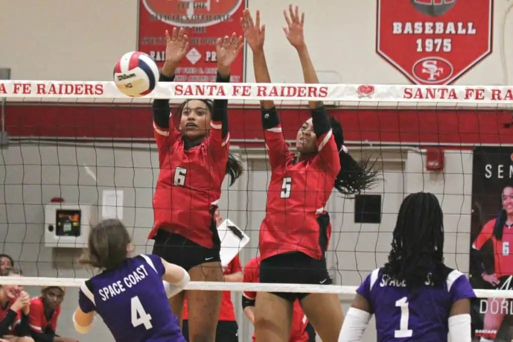 Santa Fe's Anisa Dorlouis (6) and Joselynn Sanjurjo (5) block a Space Coast hit on Tuesday.