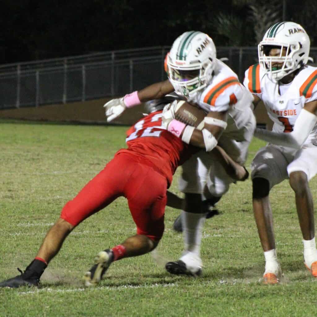 Santa Fe's Ben Hockman tackles Eastside's Antonio Hubbert on Friday.
