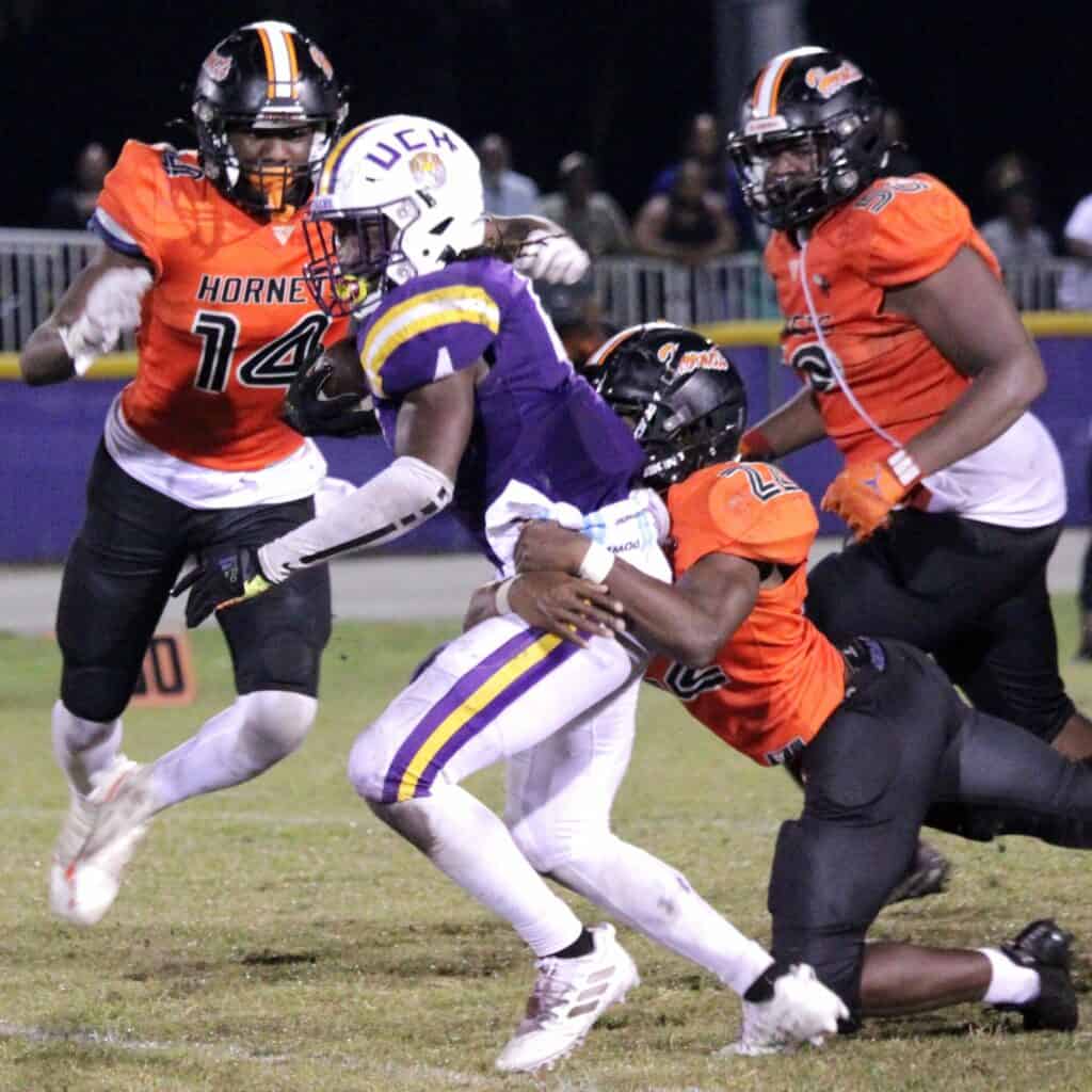 Union County's Rayvon Durant gets tackled by Hawthorne's Tyrique Robinson (22) and Jailen Ruth (14) on Friday.