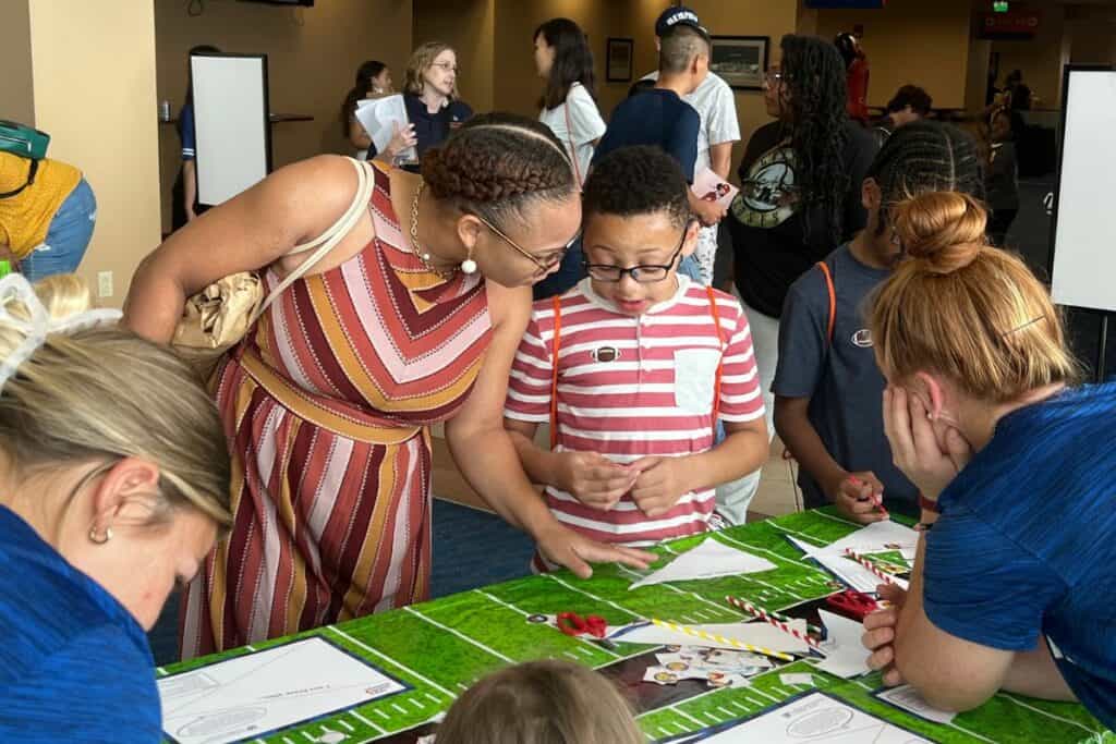 Aja Cromartie with her son at the second New World's Reading Initiative on Saturday.