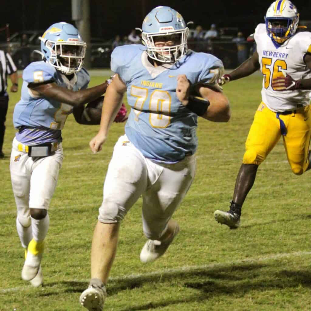 Chiefland's Anthony Blackman follows Kade Meeks to the 4-yard line against Newberry on Friday.
