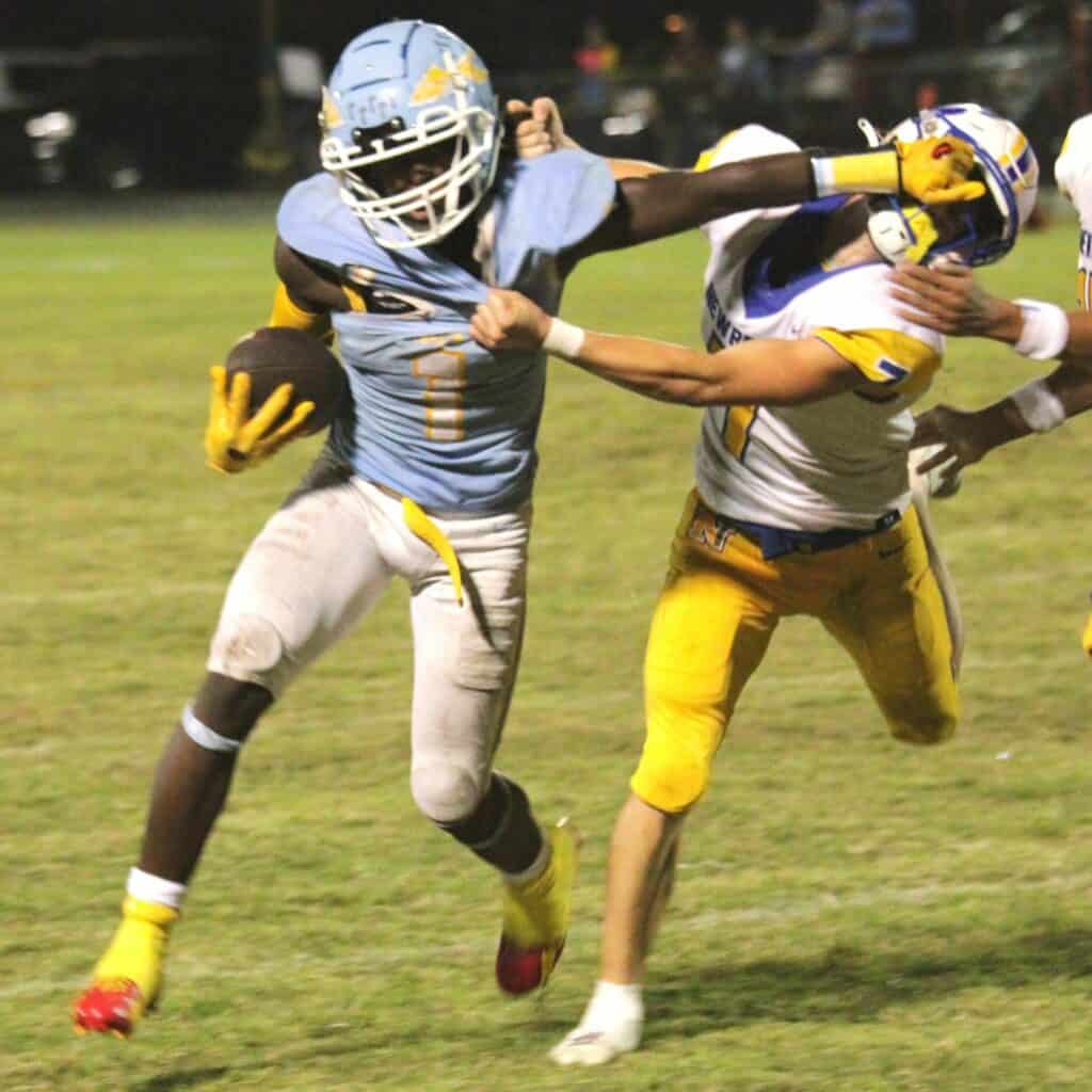 Chiefland's Dakota Fisher with a stiff arm on Newberry's Keil McGriff on Friday.