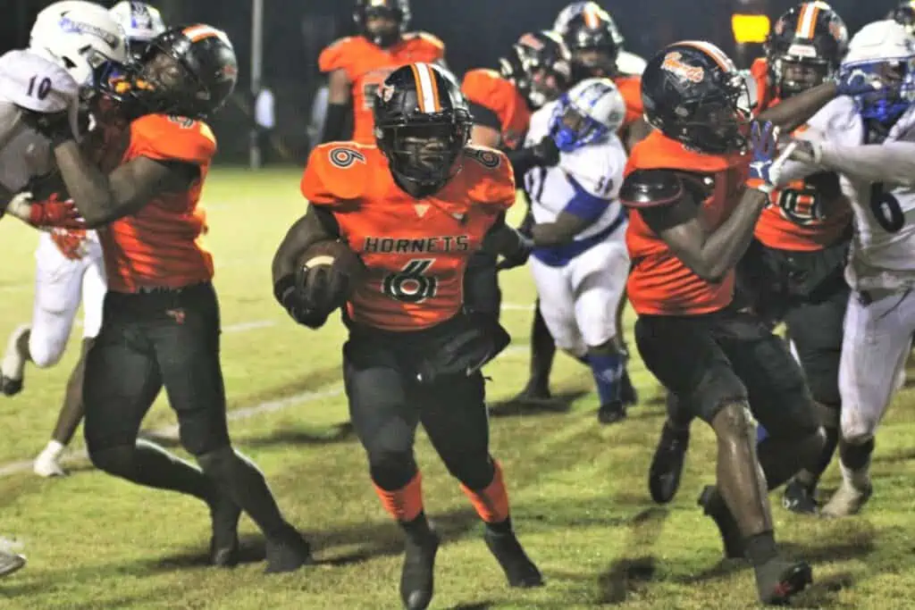 Hawthorne's Brian James searches for a hole to run through against Pahokee on Friday.