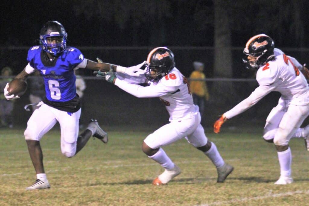 Hawthorne's Naziy Gent (18) and Darian Smith-Williams (2) pressure the Wildwood quarterback on Friday.