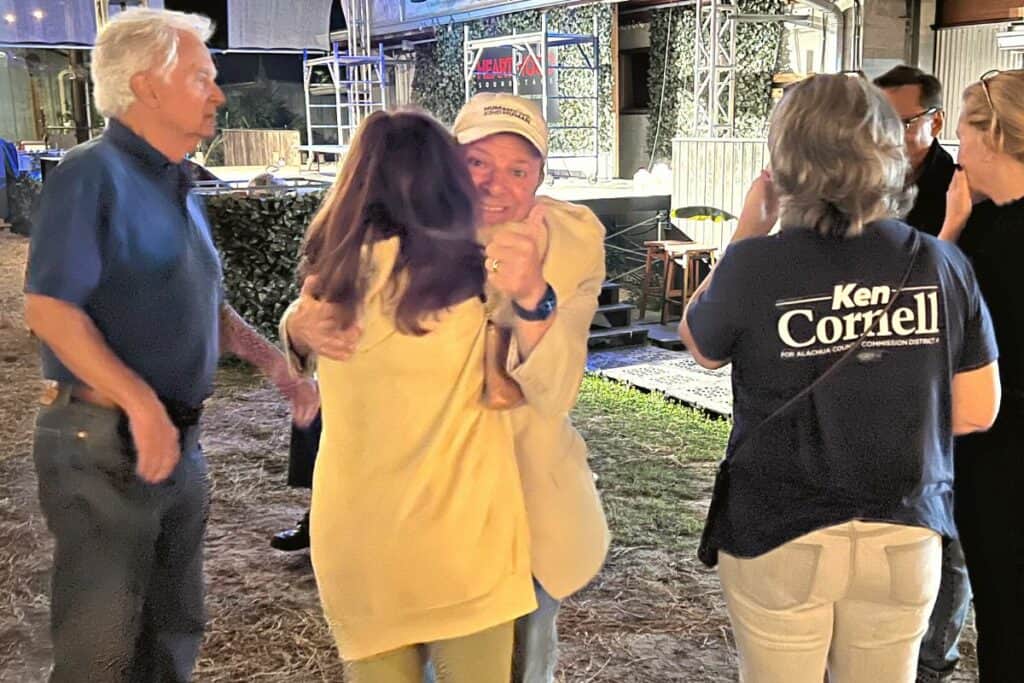 Incumbent Alachua County Commissioner Ken Cornell receives a hug following his re-election on Tuesday.