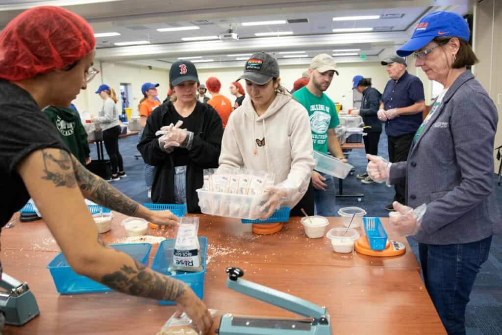 Isabella Mahboob, a zoology major, delivers a container of bags requiring weighing, sealing and labeling.