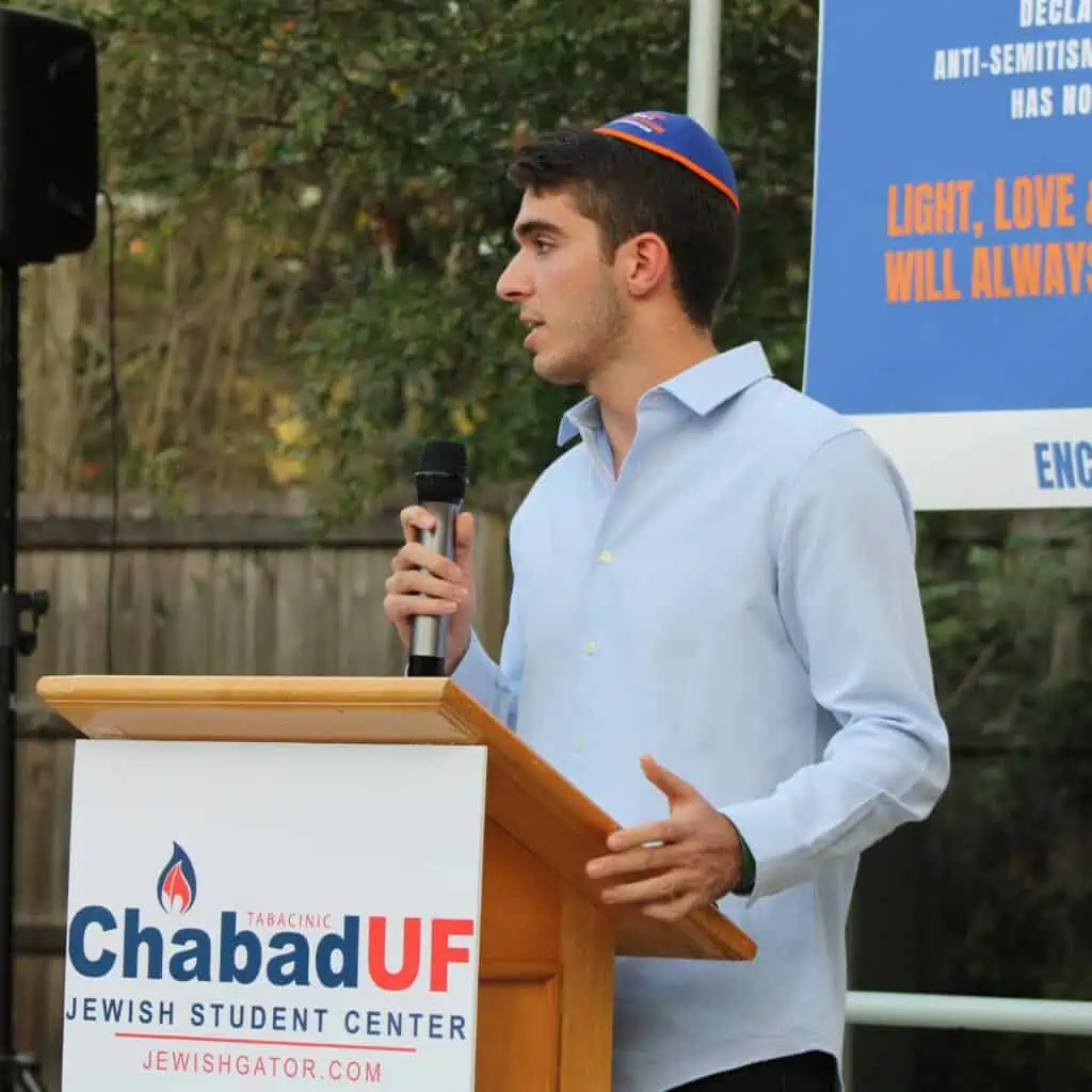 Joseph Bensabat, President of the Lubavitch-Chabad Student Group, speaks at Friday's solidarity and unity rally.