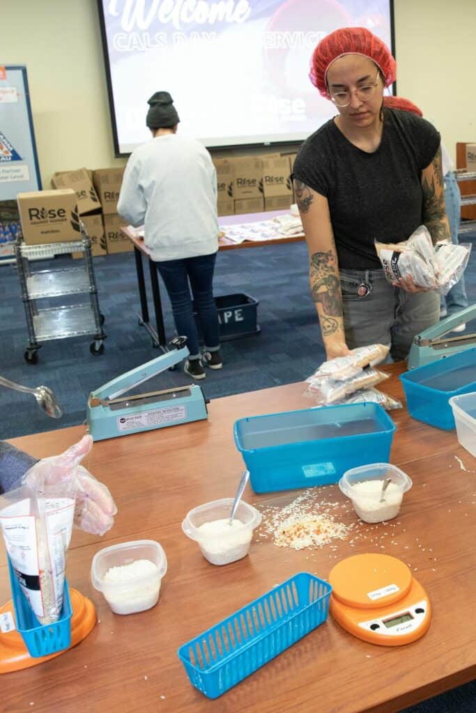 Katy Deitz, a student pursuing a masters degree in Forestry, collects sealed bags.