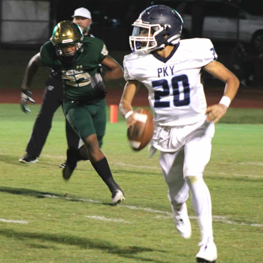 P.K. Yonge quarterback Adrian Curtis scrambles against Trinity Catholic on Friday.