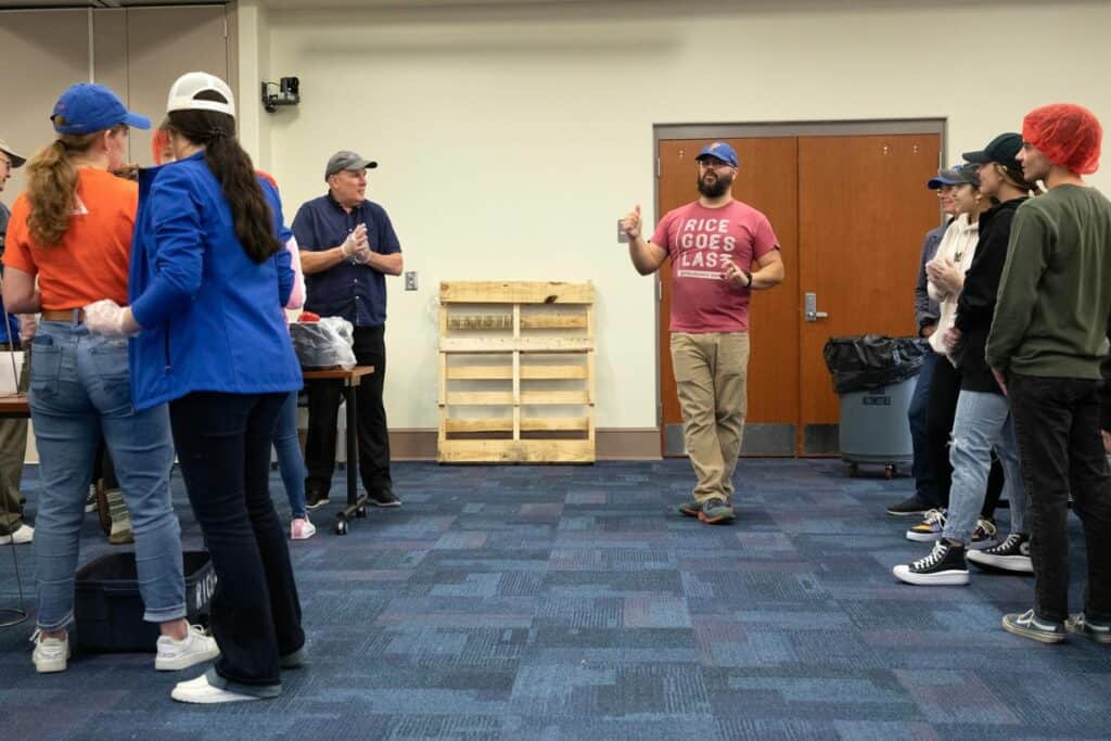 Rise Against Hunger partnership manager David Cook briefs volunteers about the process before their session begins.